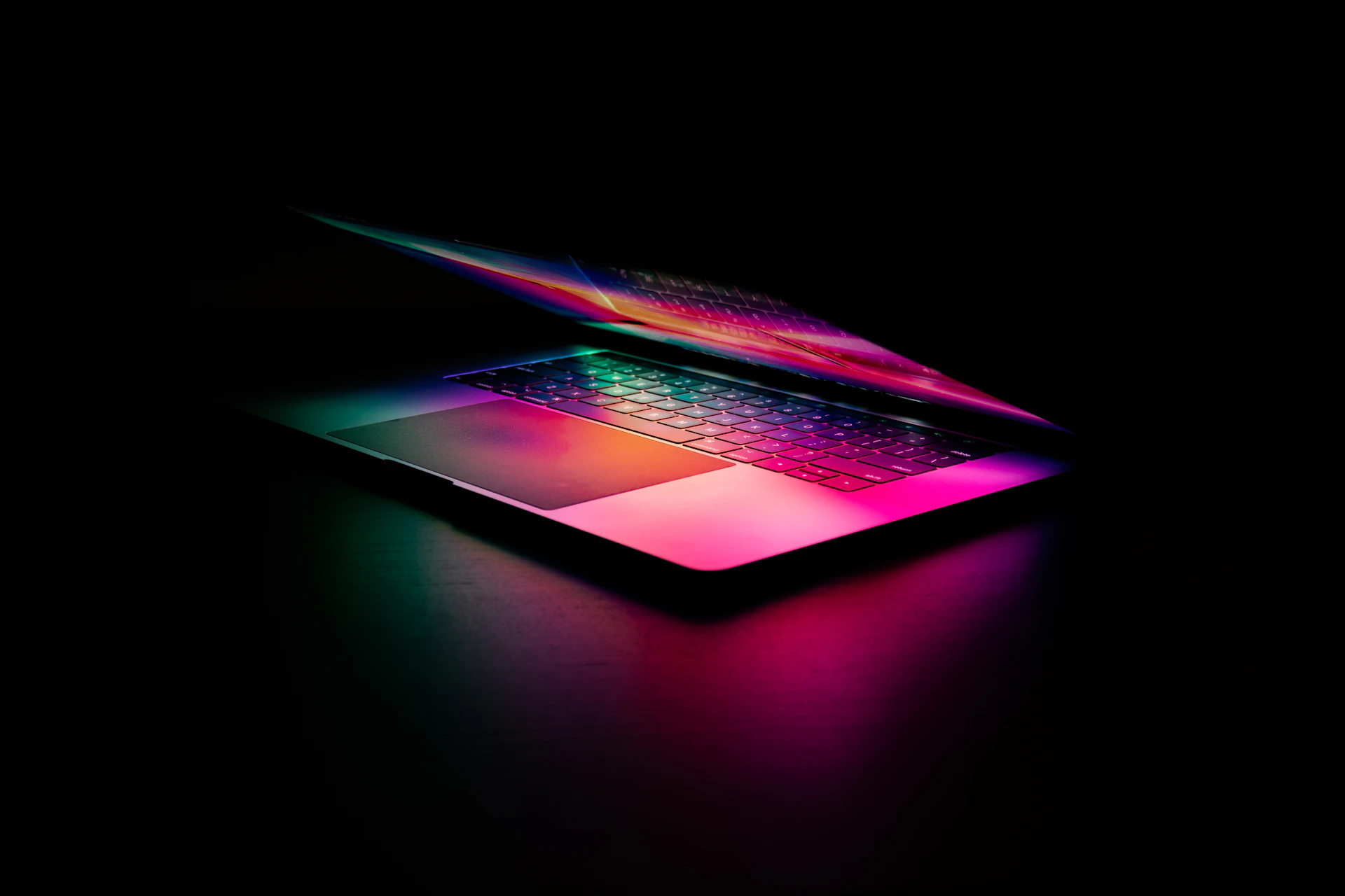 Laptop with a glowing keyboard in a dark room, ecommerce payment processing by Niche Payments