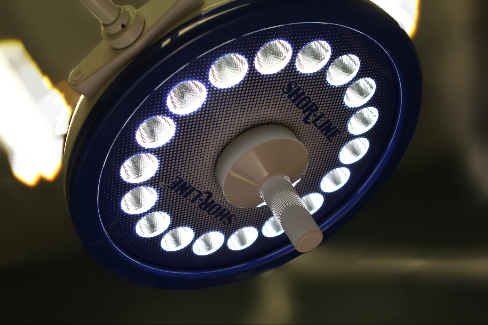 Surgical light glowing in a dark operating room, healthcare payment processing by Niche Payments
