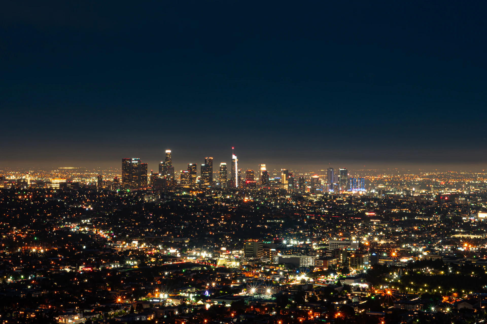 City grid lit up at night from above, high-volume payment processing by Niche Payments