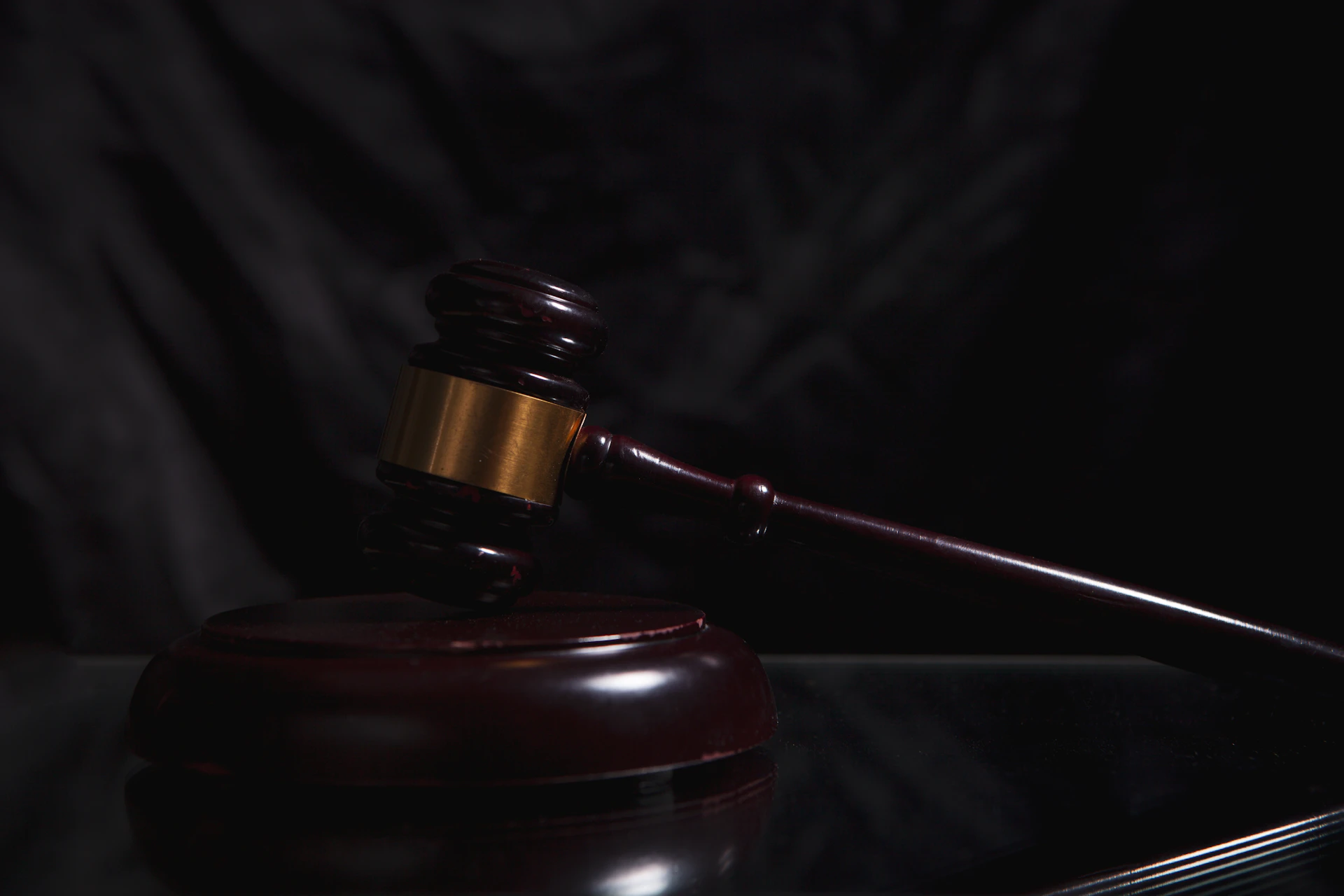 Wooden gavel resting on a dark surface, law firm payment processing by Niche Payments